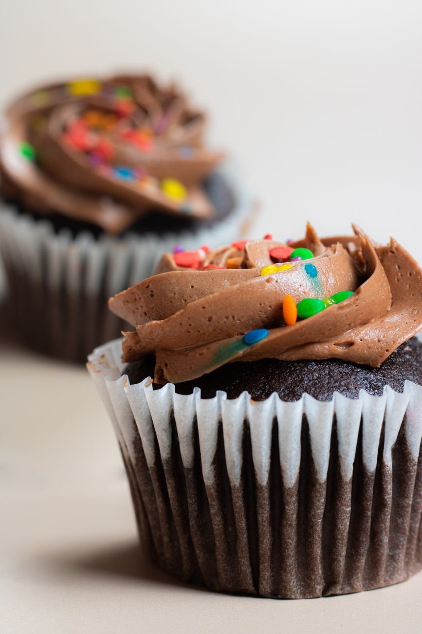 Close-up of chocolate cupcakes with rich frosting and vibrant sprinkles